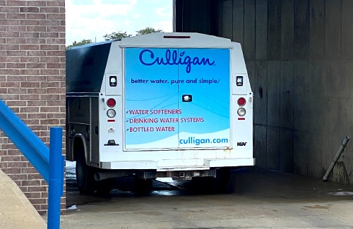 The back of a Culligan truck inside of a wash bar